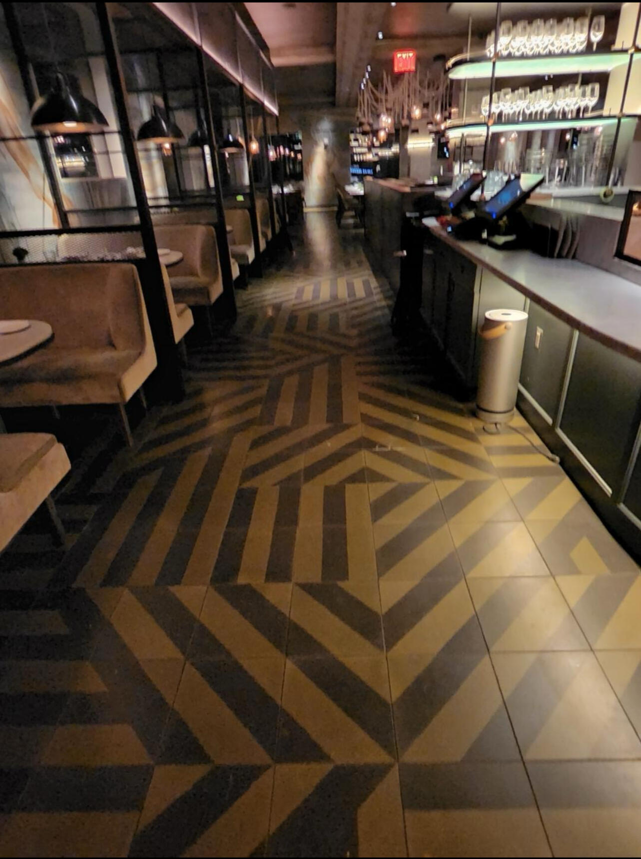 Restaurant dining room and bar with a bold patterned tile floor, cleaned after close